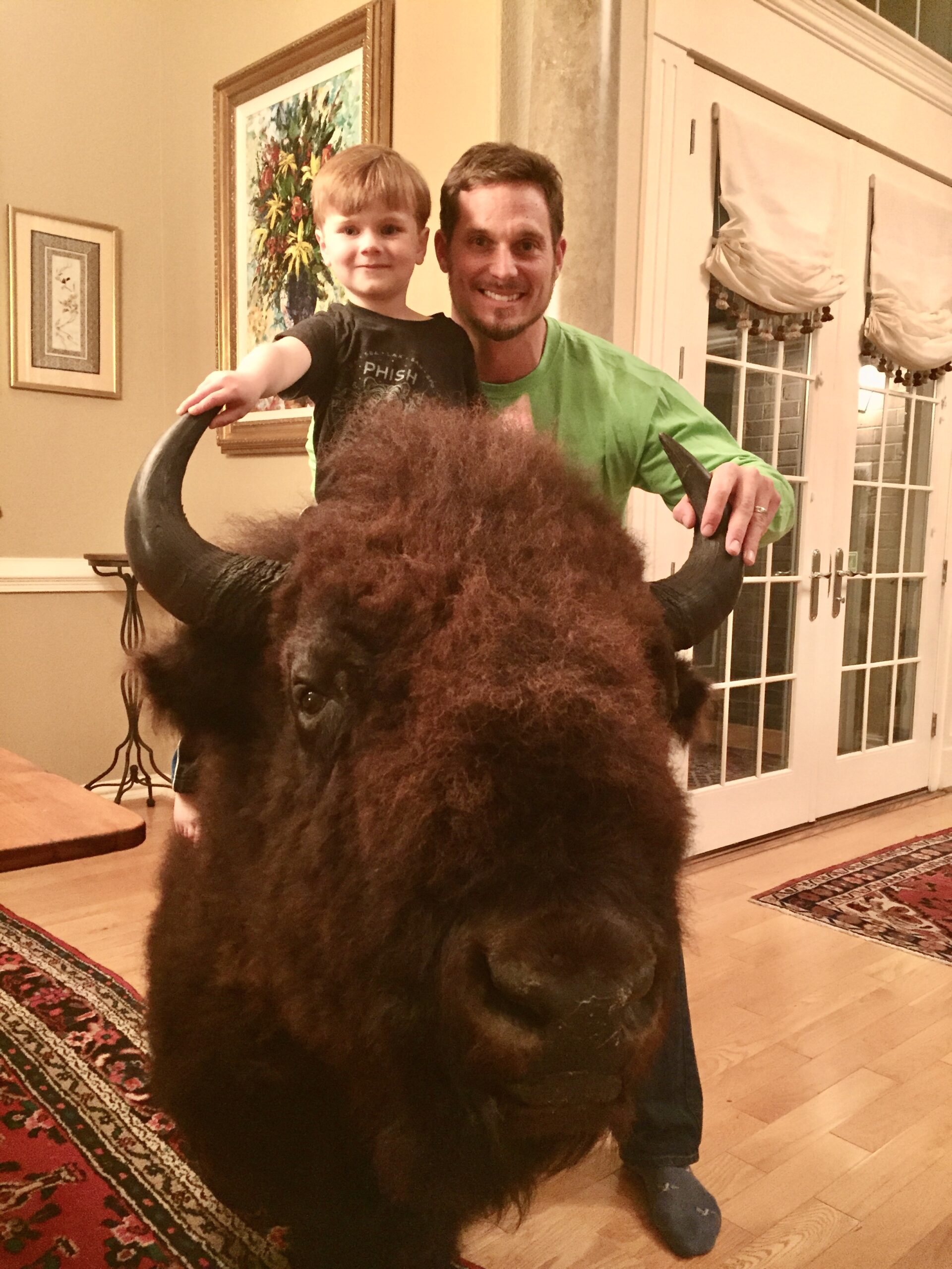 John Siver II and his child on a bison